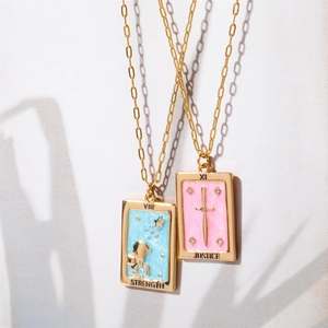 Vintage gold tarot card pendant necklaces featuring Strength and Justice enamel designs