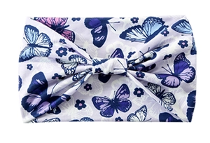 Detail of lavender wide headband featuring blue butterfly prints and a center knot design