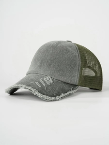 Close-up of distressed grey visor with olive mesh panel on a vintage trucker hat
