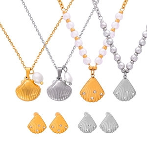 Shell shaped jewelry set with freshwater pearls and crystals in gold and silver finish
