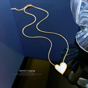 Minimalist heart mother of pearl pendant necklace on a gold snake chain with mirror finish