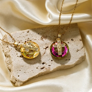 Golden portrait pendant necklace with Virgin Mary and cross on champagne silk fabric