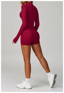 Back view of burgundy yoga set featuring thumbhole long sleeves and slim-fit shorts