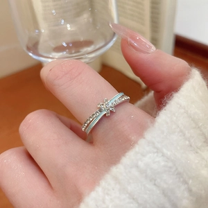 Close-up of a double-layer silver snowflake ring with light blue enamel and zircon inlay