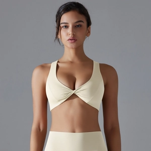 Close-up of twist-knot detail on high-elastic breathable sports bra in light beige