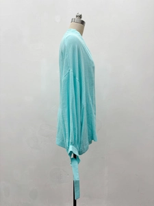 Detailed view of lake blue textured shirt fabric with tie-cuffs and seersucker finish