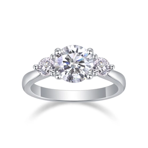 Detailed close-up of a three-stone moissanite ring in 925 sterling silver with round cut