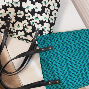 Floral and geometric printed cotton tote bags with leather handles and gold rivets