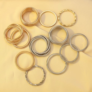 Detailed macro of gold and silver spring coil bracelets with twisted industrial textures