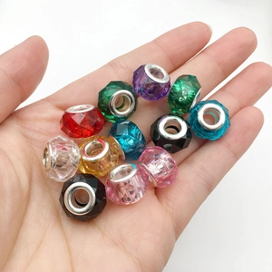 Macro shot of 13mm faceted resin beads with metal core in palm for jewelry DIY