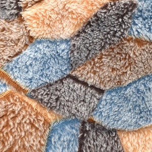 Fleece bucket hat with soccer style patchwork and plush faux fur material for winter warmth
