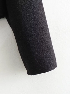 Close-up of the thick wool blend cuff on a black British style zipper jacket for women