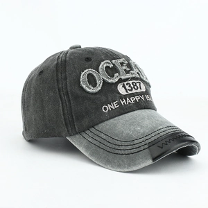 Detail of vintage gray baseball cap with OCEAN embroidery and distressed brim accents