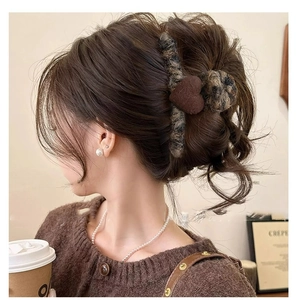 Chic brown velvet heart hair claw clip shown in a stylish half-up hairstyle