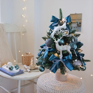 Mini desktop Christmas tree with blue bows, LED lights and natural wooden base
