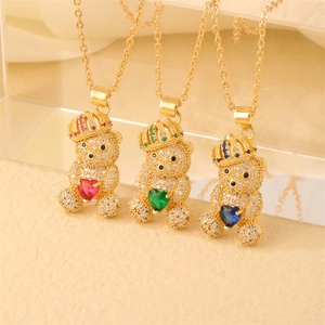 Detailed comparison of gold bear heart pendants with red, green, and blue crystal pavé