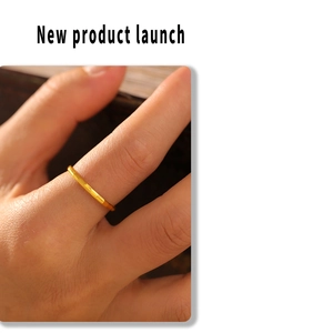 Close-up of minimalist 18k gold plated titanium ring with polished geometric texture