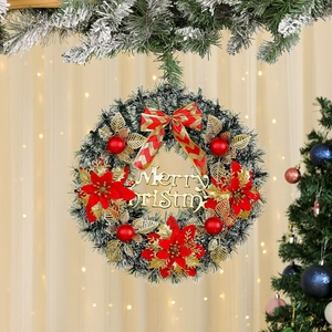 Detail of Christmas wreath with red poinsettia, gold leaves, and Merry Christmas sign