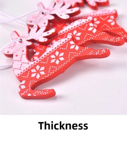 Detailed view of red wooden reindeer ornaments with white snowflake patterns and hanging ropes