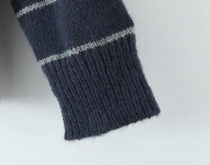 Detail of ribbed cuffs on a navy blue knitted polo shirt with grey stripes texture