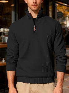 Men's black half-zip corduroy sweatshirt featuring ribbed texture detail in outdoor setting