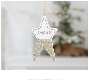 Close-up of golden and white star ornament with X-MAS text on a festive Christmas tree
