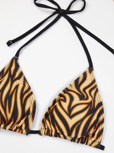 Detail of halter bikini top with vibrant orange and black tiger print and frill edges