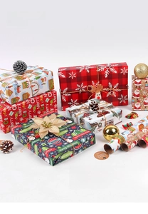 Detailed view of Christmas wrapping paper with festive patterns, pine cones, and gold baubles