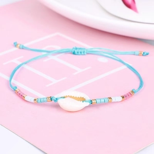 Close-up of sky blue woven Evil Eye shell bracelet with colorful beads and adjustable cord