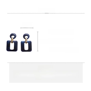 Detail view of deep blue marble acrylic geometric earrings measuring 5.6cm by 3.2cm