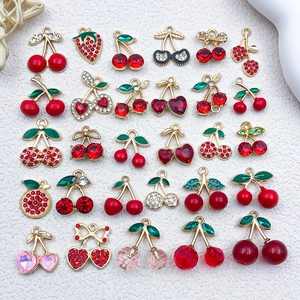 Detailed macro view of red cherry and heart alloy pendants with sparkling rhinestones