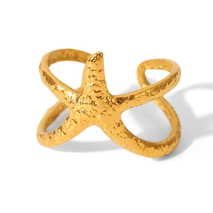 Detail of a golden starfish open ring with unique hammered metal texture for women