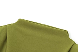 Detailed close-up of olive green pleated shoulder seam on a mock neck textured dress