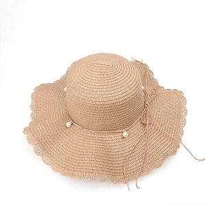 Women's summer straw sun hat with wavy brim, pearl accents and delicate bow decoration