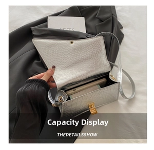Silver crocodile texture rectangular handbag showing inner capacity for phone and makeup