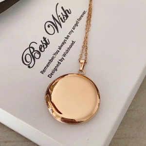 Detail of rose gold locket necklace with mirror finish on Best Wish card packaging