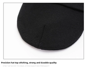 Detailed close-up showing the premium stitching and knit texture on the black beanie cap