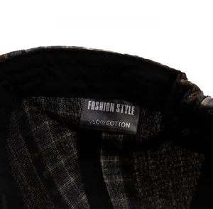Detail view of the internal cotton care label and sweatband on the plaid newsboy cap