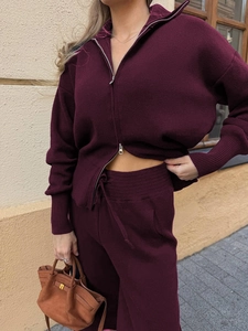 Detail of dark burgundy knitted cardigan with double zipper and drawstring pants