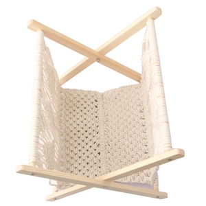 Close-up of woven cotton rope magazine rack showing interior space and pine wood frame
