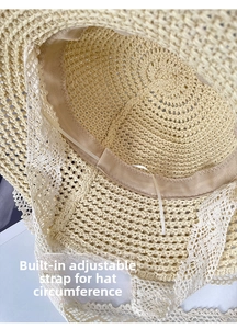 Detail of beach straw hat featuring internal adjustable drawstring and white lace trim
