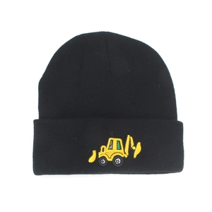 Detailed close-up of yellow excavator embroidery on a black ribbed knit beanie for boys