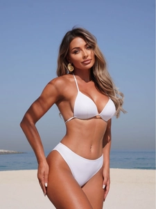 Three-piece white halter bikini set with high-cut bottoms and mesh skirt for beach vacation