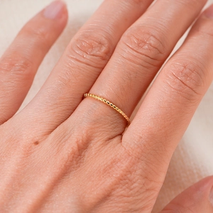 Minimalist S925 sterling silver twisted rope ring in gold finish worn on finger