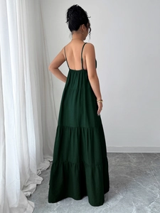 Elegant dark green backless maxi dress with spaghetti straps and a flowy cotton linen hem