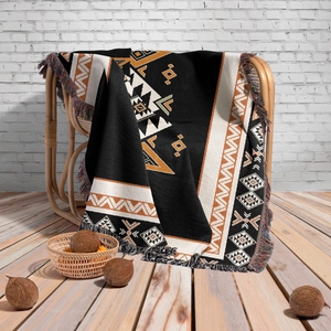 Close-up of Bohemian knit camping blanket with geometric patterns and fringe detail