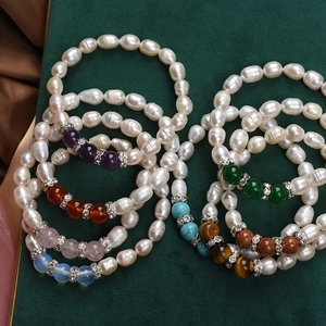 Baroque freshwater pearl bracelets with colorful gemstone accents on green background