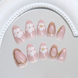 Elegant press-on nails with 3D white flowers and gold liquid metal lines on nude pink base