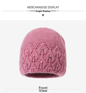 Close-up of pink knit hat featuring hollow leaf patterns, faux pearls and bright rhinestones