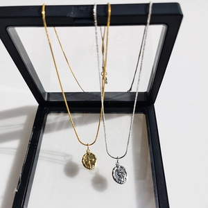 Double-sided mermaid pendant necklace in gold and silver finish with jewelry display box